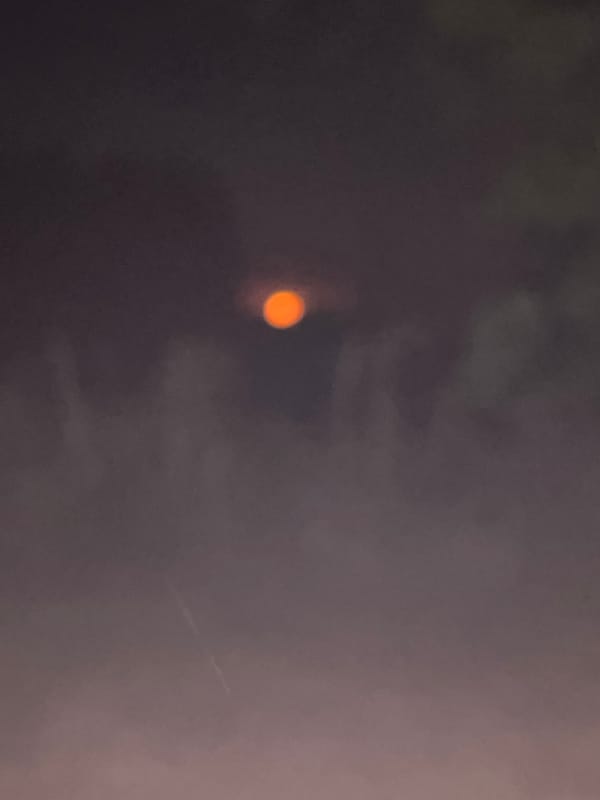 Obscured orange orb observed in low-light conditions