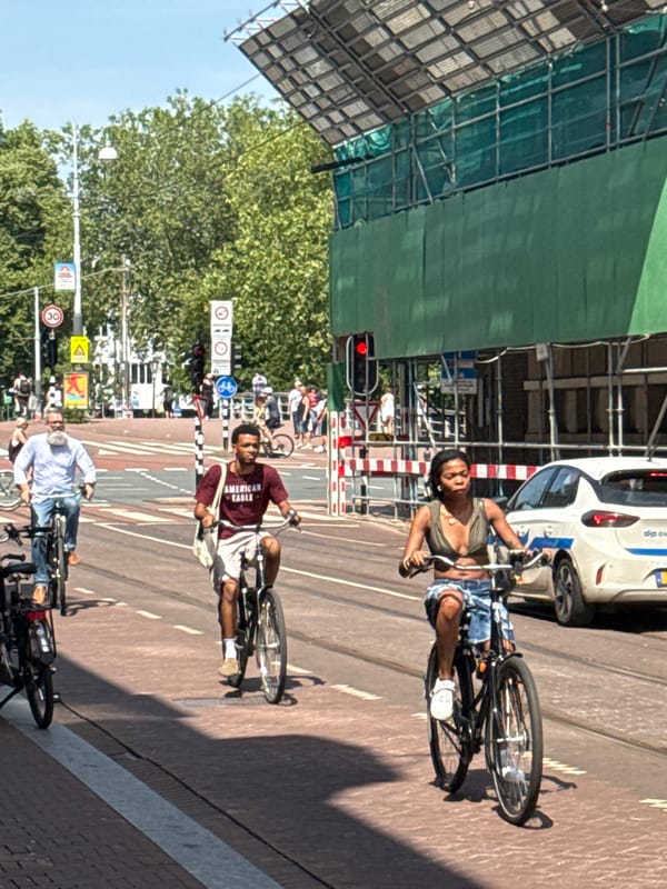 Amsterdam on a sunny afternoon, streets and canals in motion