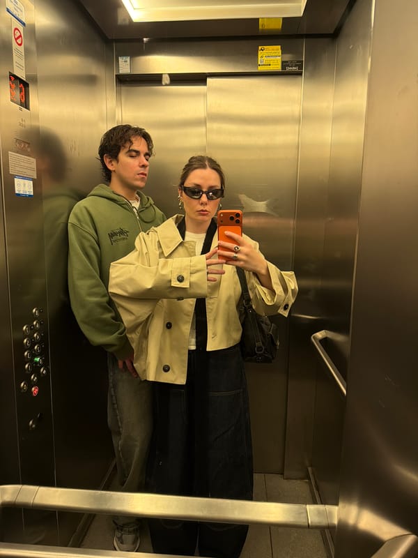 Two people ride elevator in Tel Aviv building