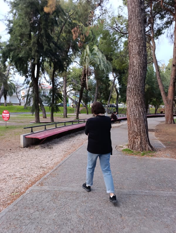 Woman walks in coastal park during sunset in Antalya