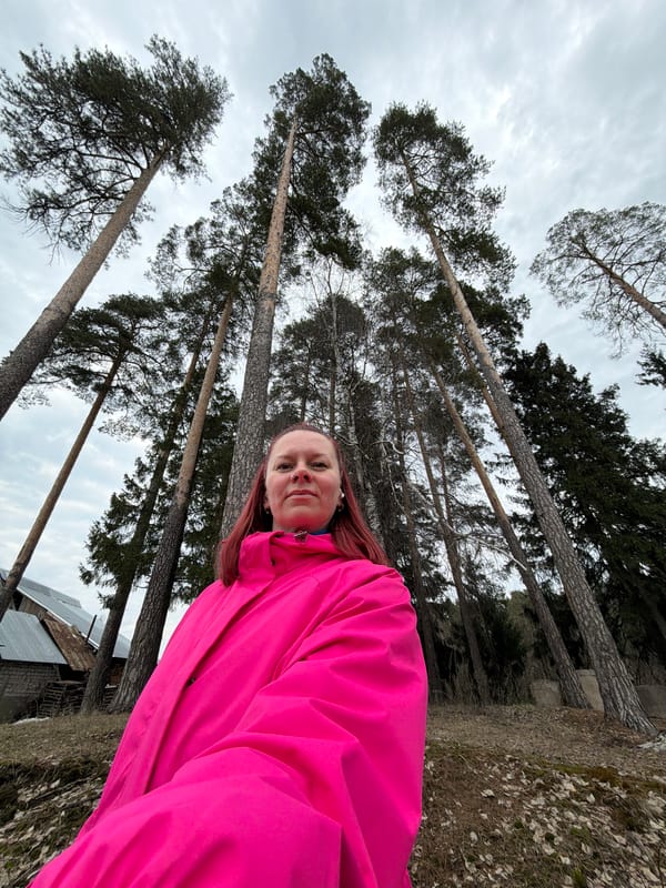 Woman takes forest selfies during cloudy afternoon walk in Chaikovsky