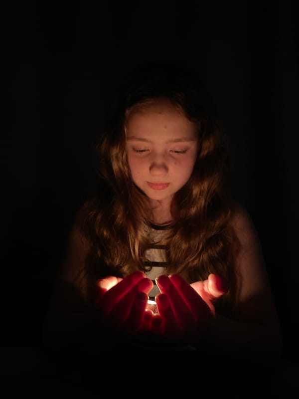 Girl photographed with glowing hands in unknown location