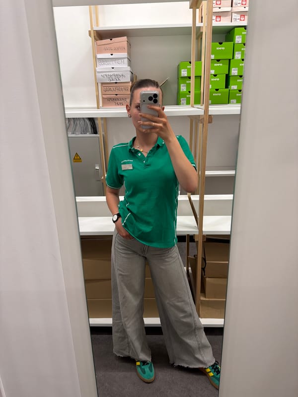 Person takes mirror selfie in shoe storage room