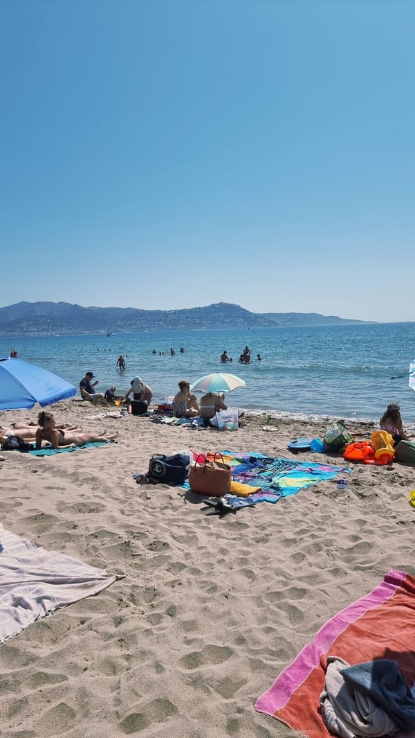 Busy summer morning at Empuriabrava beach, parasailing included