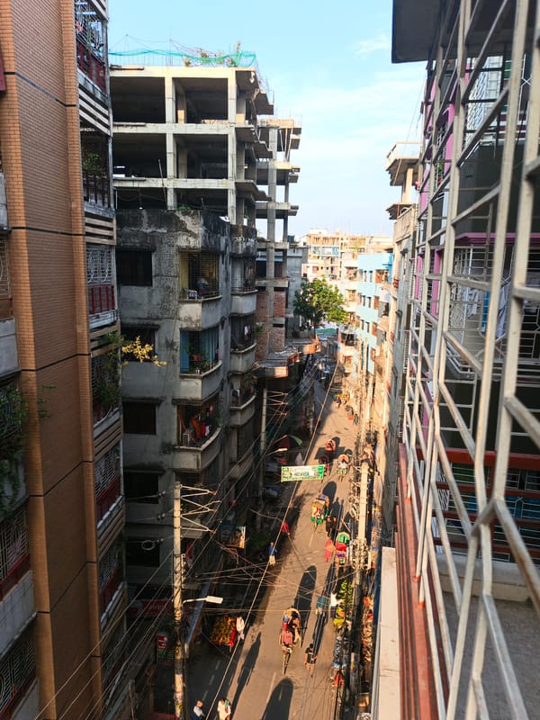 Street vendors sell vegetables in downtown Dhaka corridor