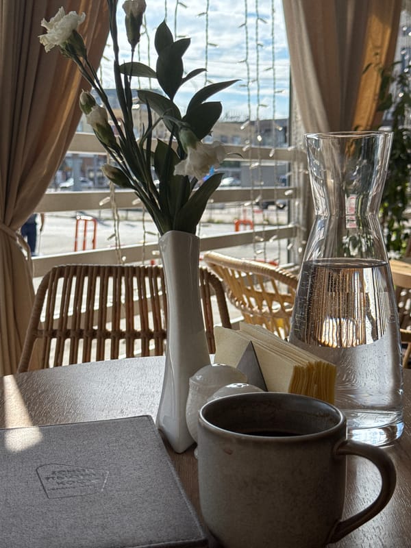 Café table setting with coffee and menu in Omsk
