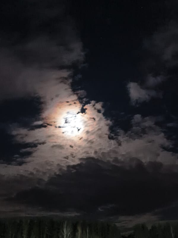 Full moon observed through clouds in Noviy, Russia