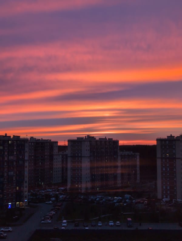 Saint Petersburg sunset paints the sky over apartment rooftops