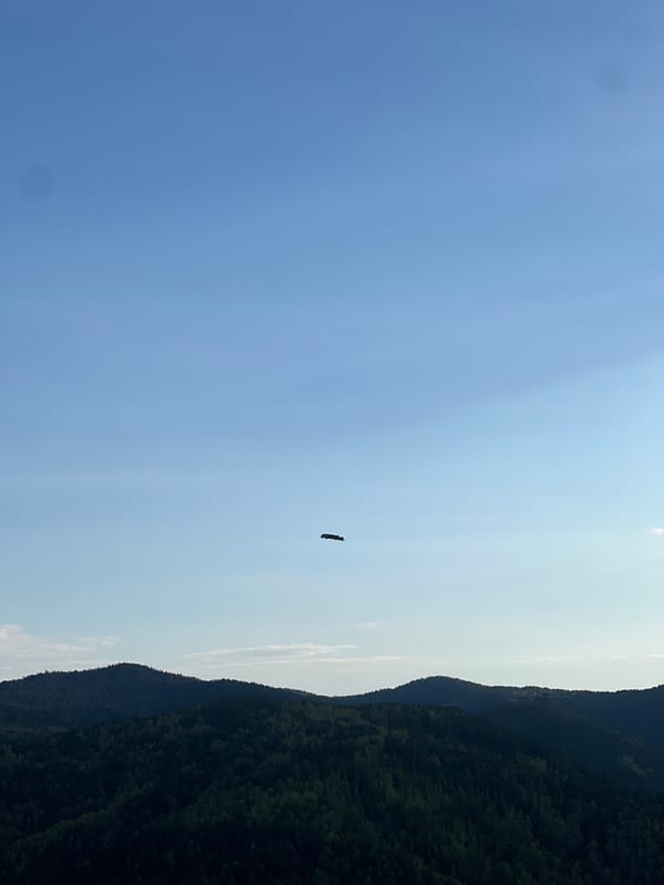 Clear skies over wooded mountains captured in Krasnoyarsk region