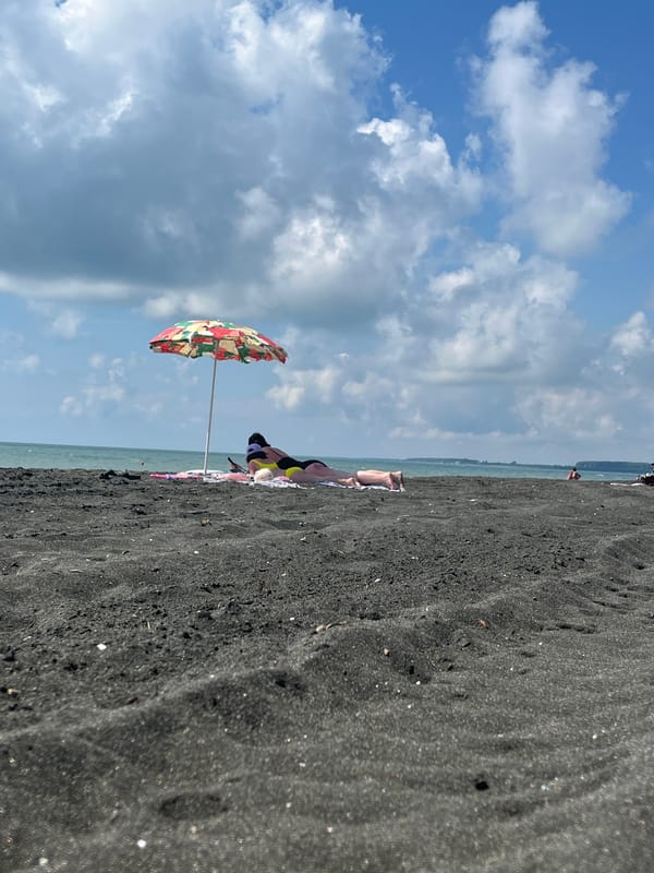 A lazy morning on Ureki's black sand beach