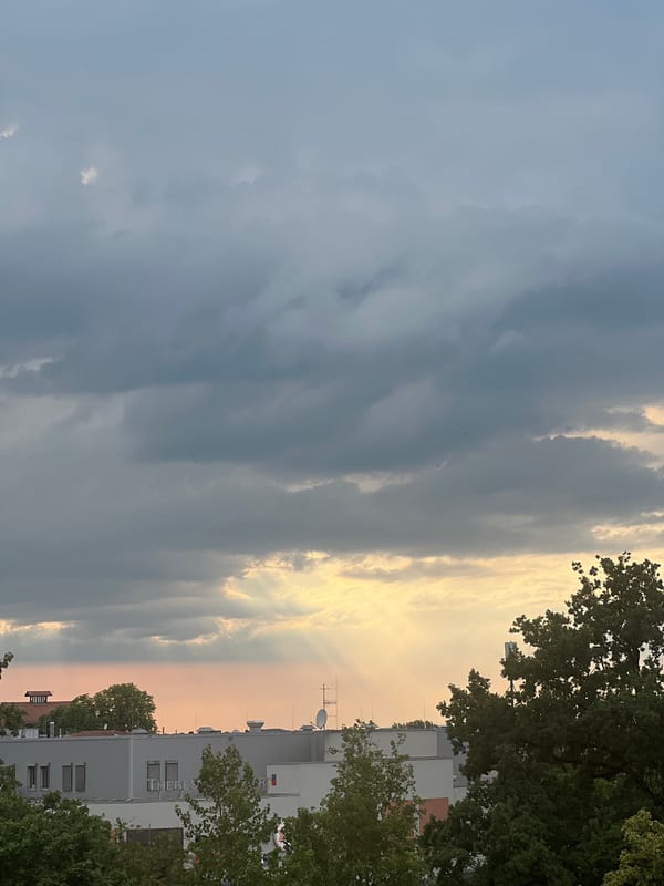Rooftop views and cloudy skies over Straubing on a summer afternoon