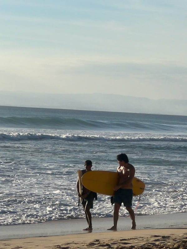 Two surfers spotted on Kuta Selatan beach amid calm conditions
