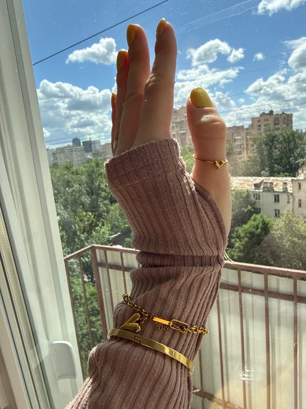 Woman photographs herself in mauve sweater in Moscow