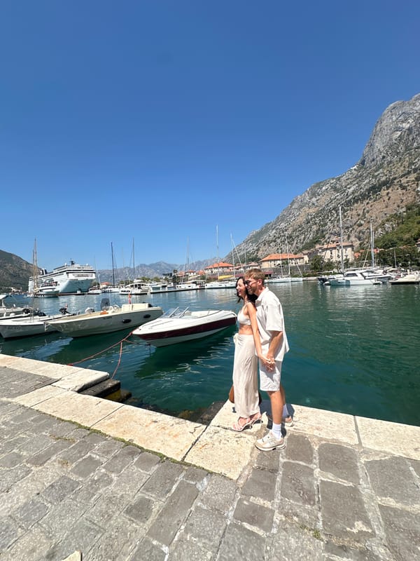 Sunny morning on Kotor's waterfront with cruise ship in harbor