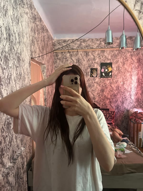 Person Takes Mirror Selfie in Blizhnii Khutor Room
