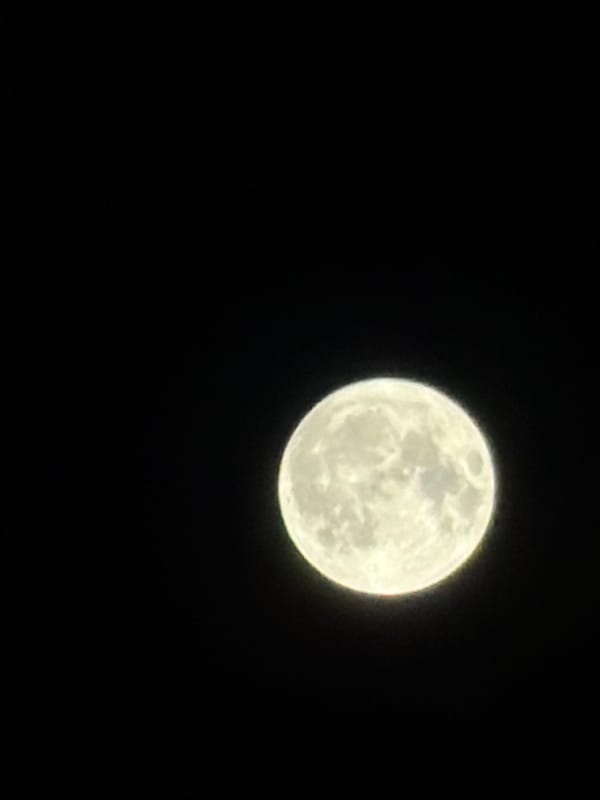 A night out in Burgas: full moon, lit streets, restaurant glow.
