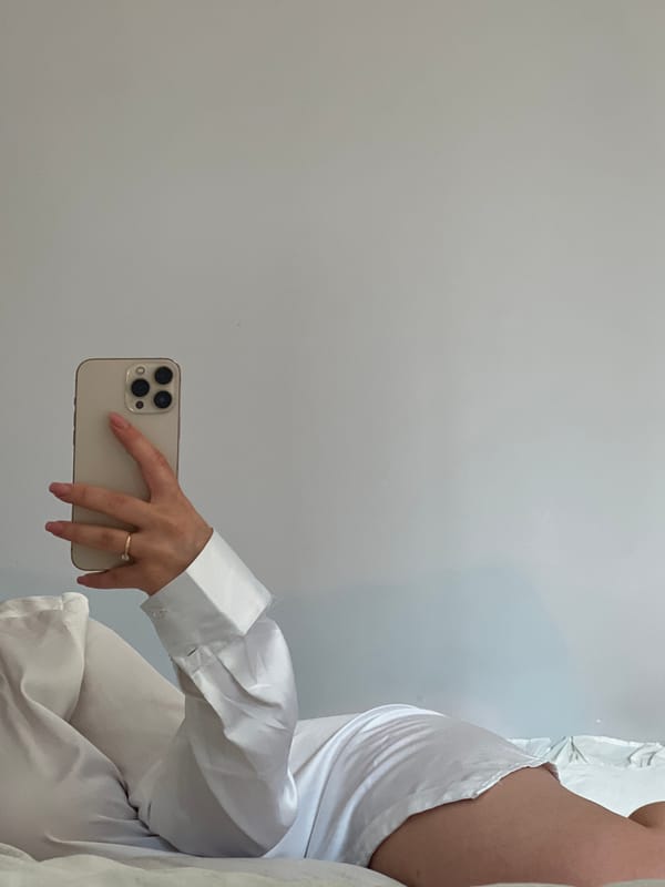 Person takes multiple selfies with cat in Ternopil bedroom