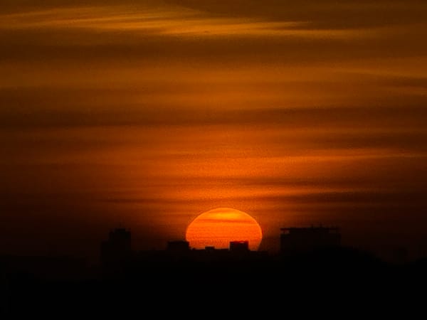 Dramatic sunrise illuminates wind turbines over Maasdijk, Netherlands