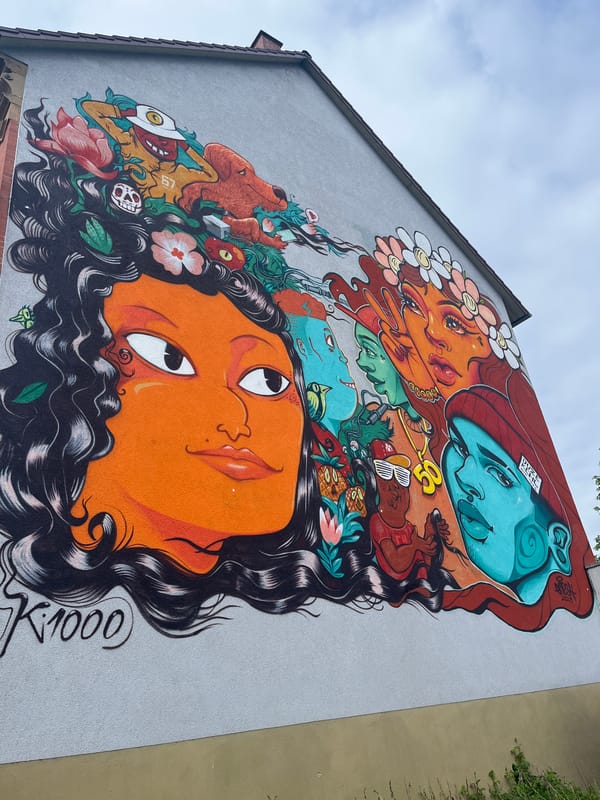 Vibrant street mural with stylized faces spotted in Kehl