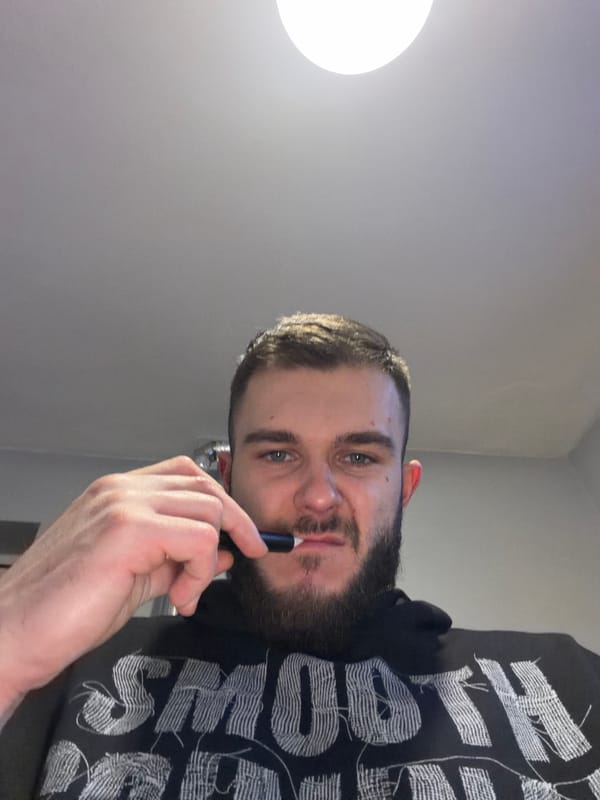 Man with beard holds pen-like object in Dupnitsa