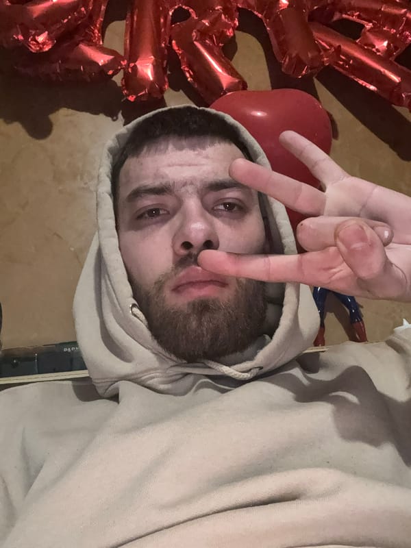 Man makes three-finger gesture amid balloons in Bulgarian village