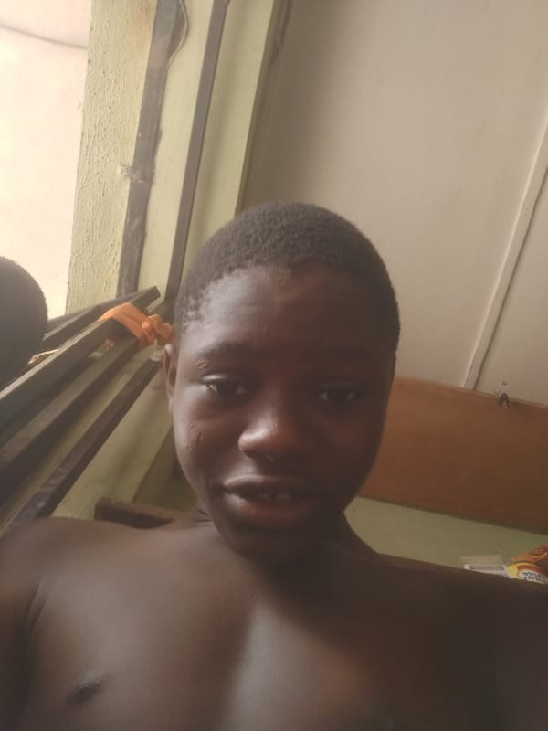 Young man photographed indoors in Shangisha, Nigeria