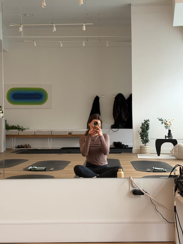 Woman takes mirror selfie in modern Montreal apartment