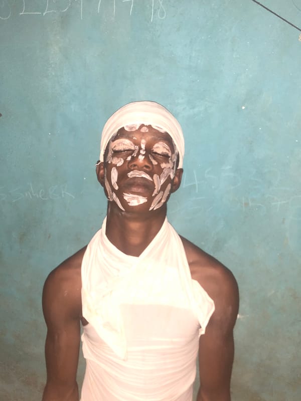 Traditional ceremony participants observed in white paint, Idima Nigeria
