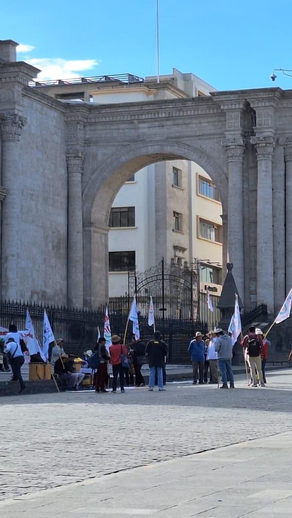 People gather at stone archway in Arequipa, Peru