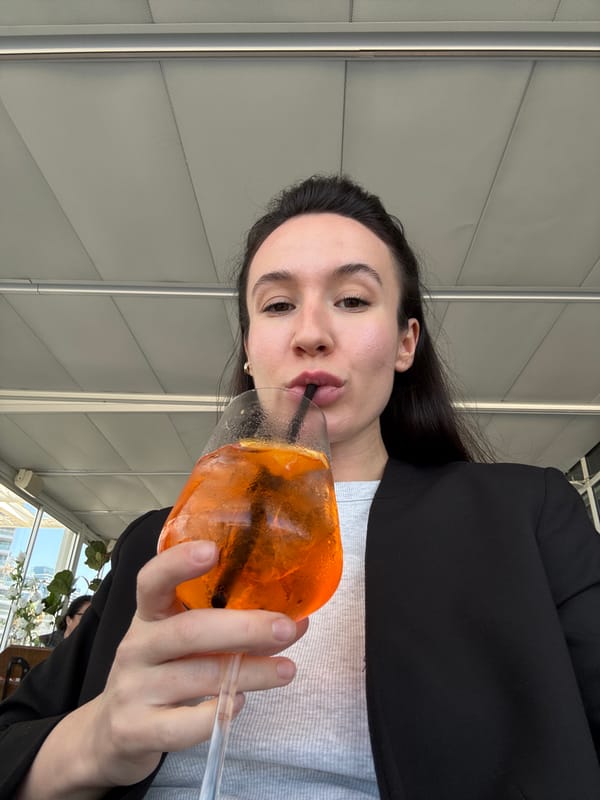 Woman enjoys drink at beachfront Tel Aviv restaurant