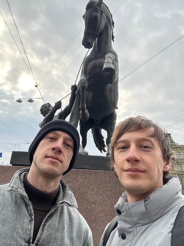 Two tourists take selfie at Saint Petersburg monument