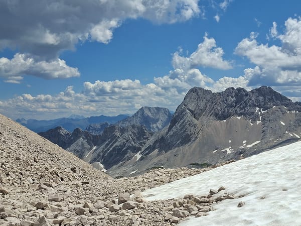 Hiking the rocky upper slopes of Zugspitze on a clear summer day
