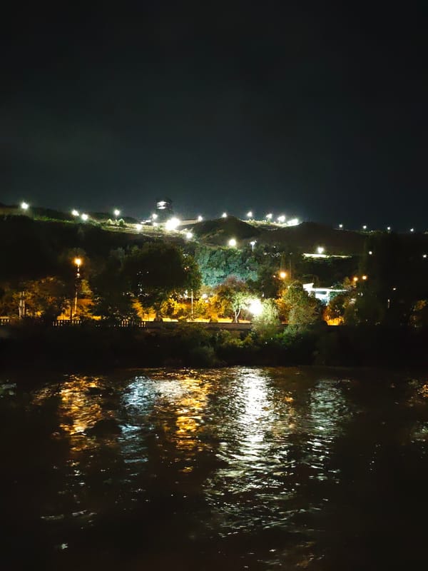 Tbilisi at night: riverfront, apartments, and lit-up streets