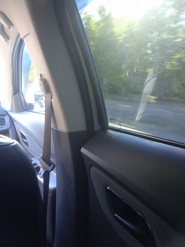 Backseat view on a sunny drive through Karaganda