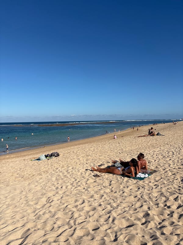 Morning beach activities unfold under clear skies in Kuta Selatan