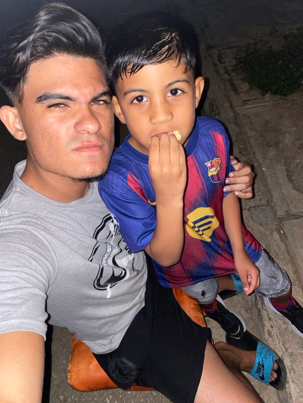 Father and son play baseball under crescent moon in Venezuela