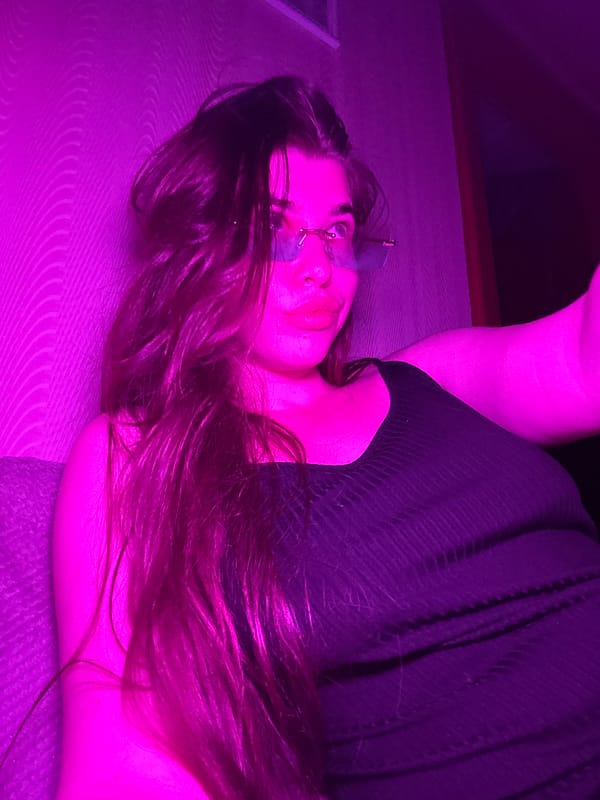 Evening selfie session with colorful lighting in Russian bedroom