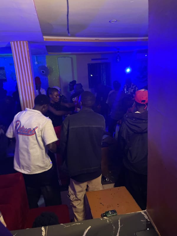 Late-night gathering at a Durumi lounge, blue lights and crowds