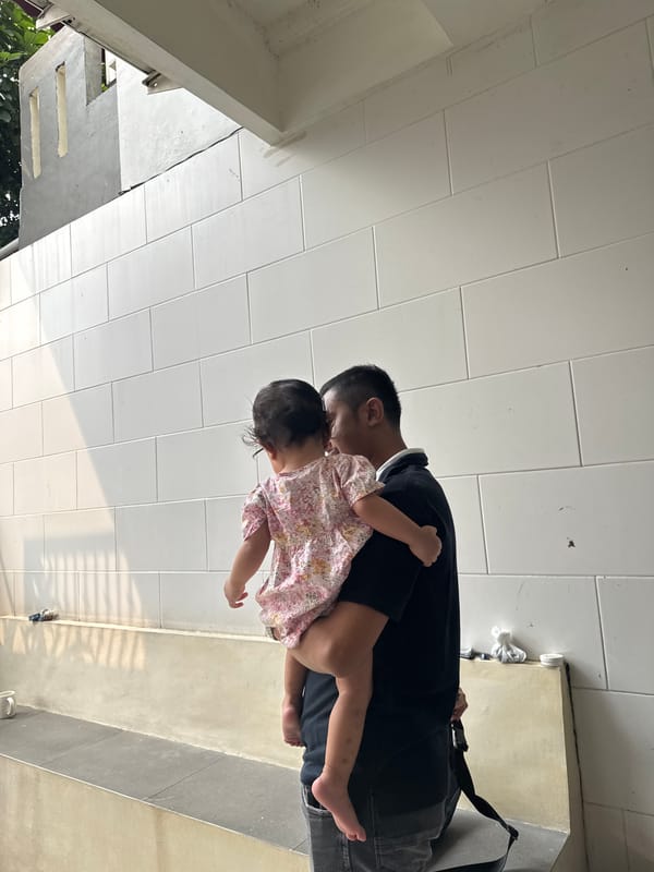 Man carries distressed child in Bekasi residential area