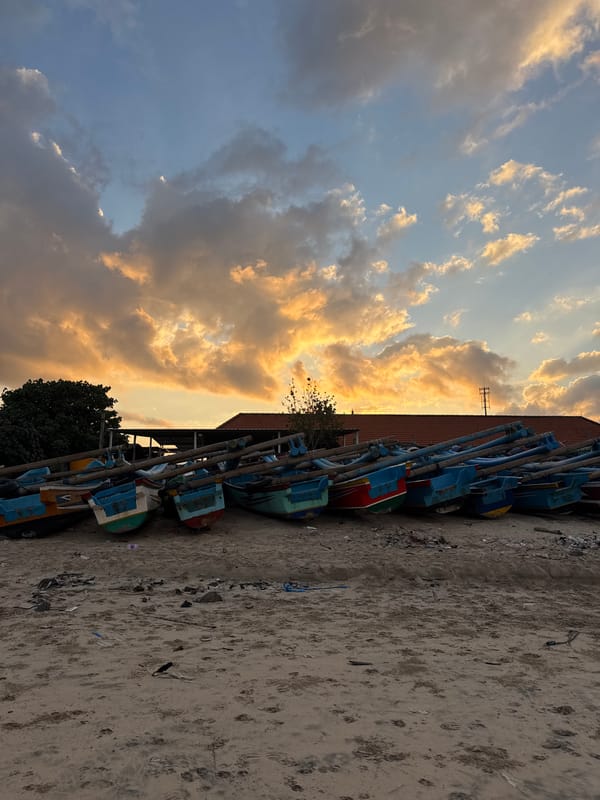 Traditional fishing boats launched at sunset in Kuta, Indonesia