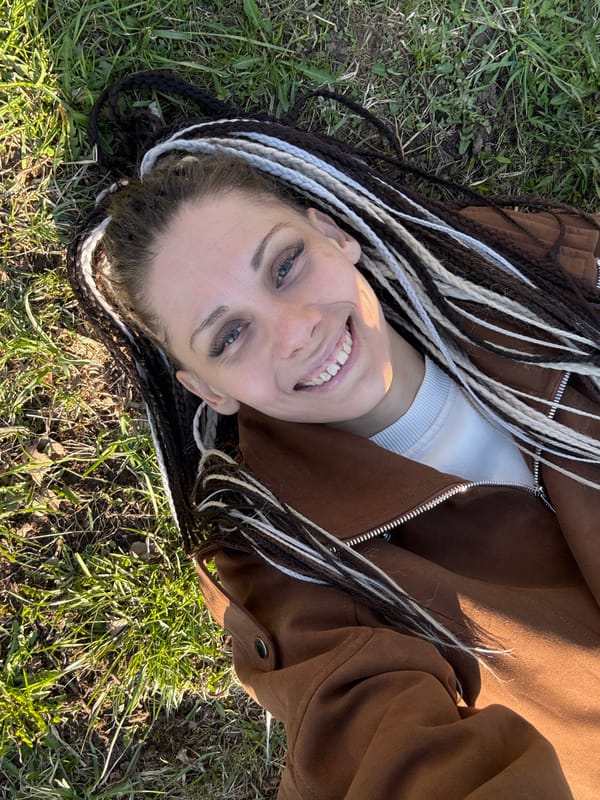 Woman rests in grassy area in Zhukovo, Russia
