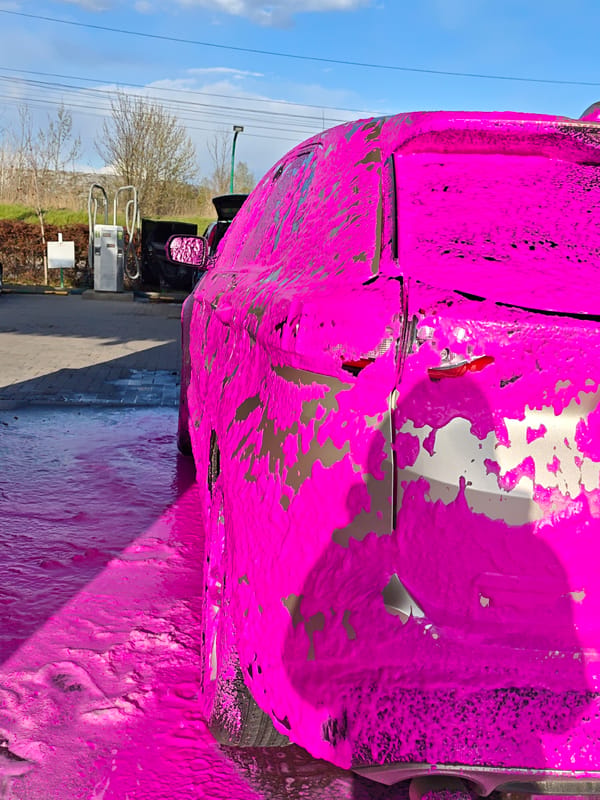 Car covered in pink foam at Vinnytsia car wash