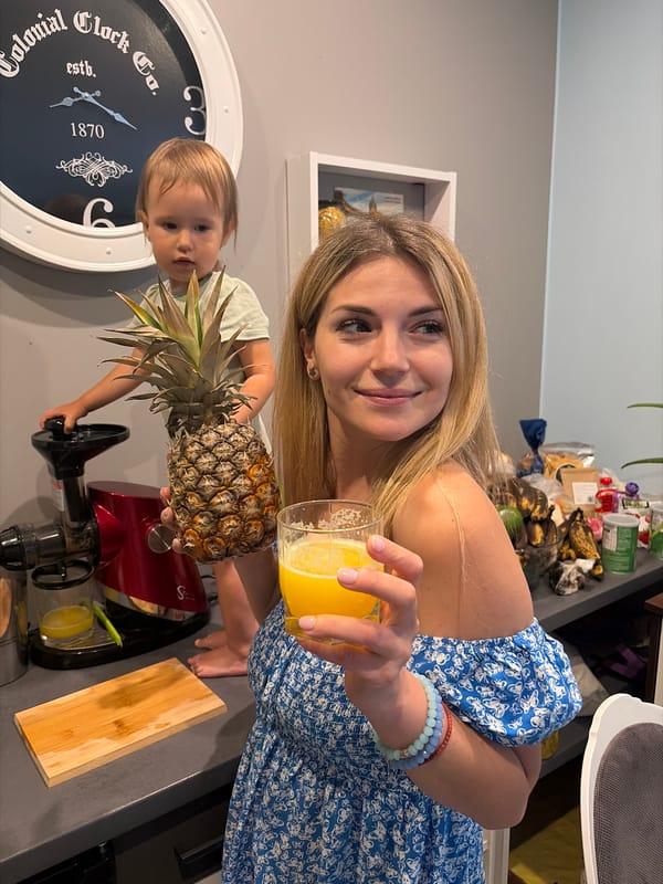 Woman prepares fresh juice with pineapple in Wisła kitchen