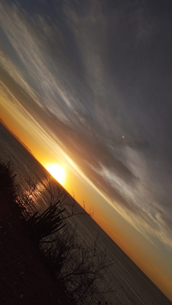 Sunset documented across Juan Griego's Caribbean coastline and roads