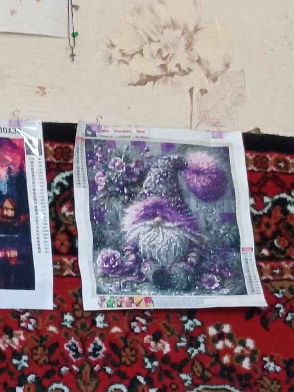 Diamond painting collection on display, finished and in progress
