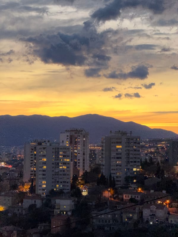 Nighttime view captures illuminated Rijeka cityscape from above