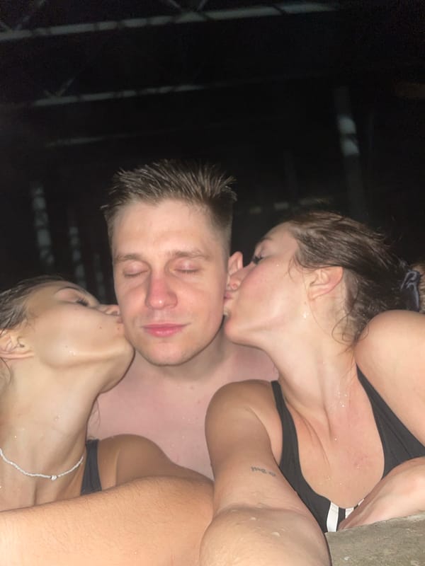 Three people share intimate moments in pool setting