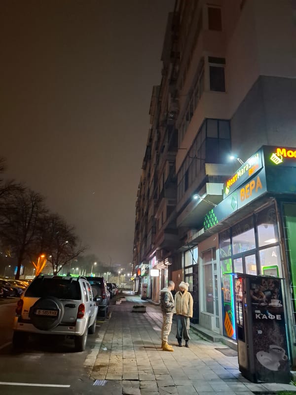 Evening pedestrians spotted near North Market storefront in Varna