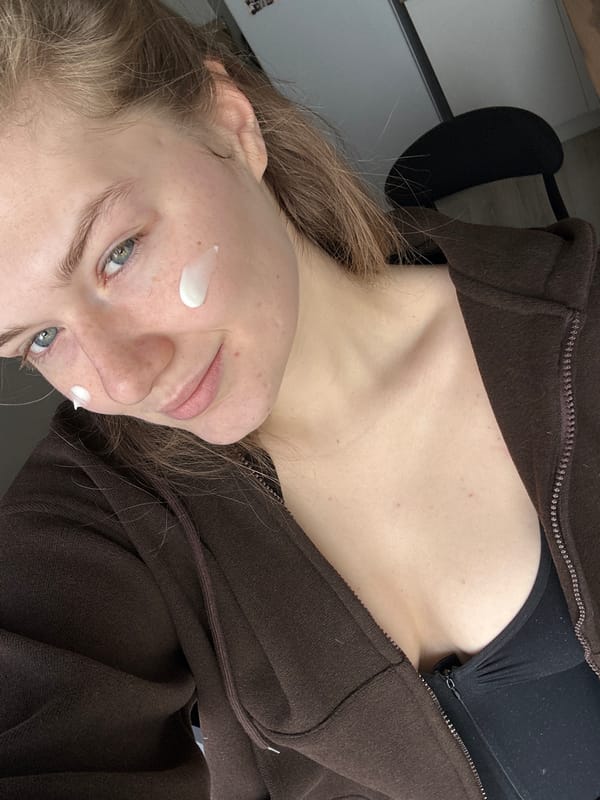 Morning routine captured: woman with face cream, mug in Kazan