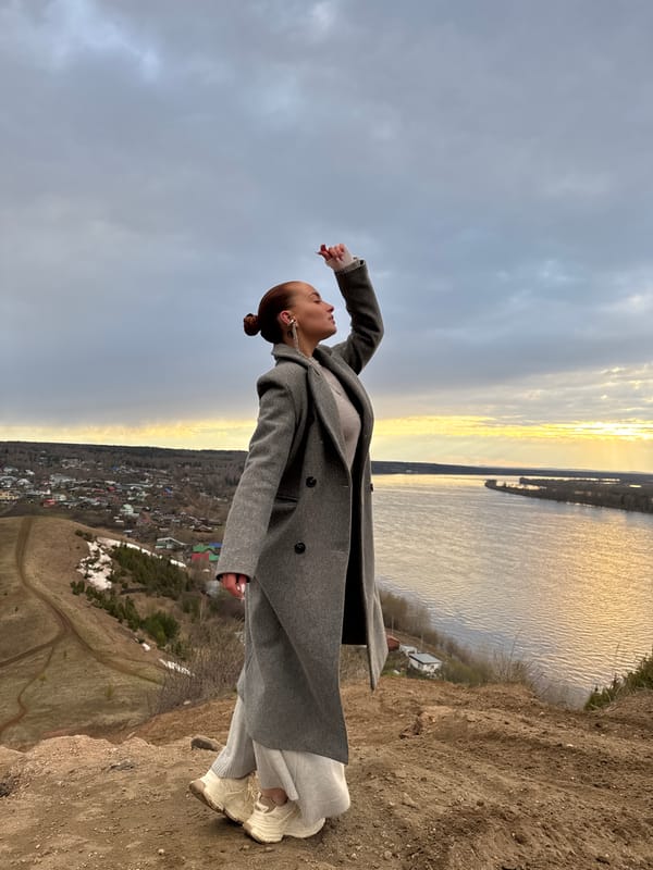 Woman photographed on cliff overlooking river in Ольховka, Russia